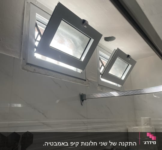 חלונות אלומיניום פתוחים בקיר חדר אמבטיה